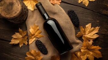 bottle of wine surrounded by autumn leaves and berries photo