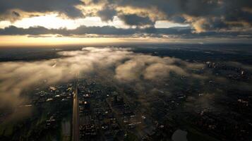 Aerial view of city with smog and clouds at sunset photo