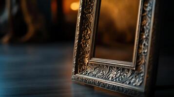 An ornate frame sits on a wooden floor photo