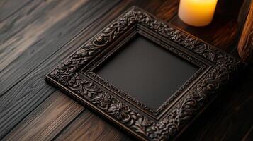 An empty picture frame on a wooden table with a candle photo