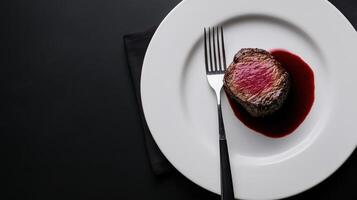 Juicy filet mignon with red wine sauce on plate photo