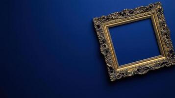 Elegant gilded picture frame on deep blue background photo