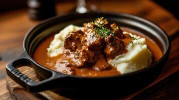 Delicious curry with braised lamb served on creamy mashed potatoes photo
