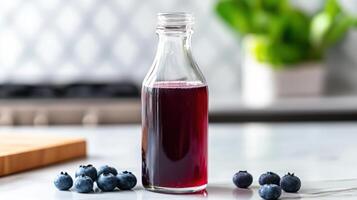 A bottle of blueberry juice sits on a counter photo