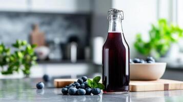 Blueberry syrup in a bottle on a kitchen counter photo