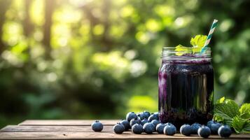 Fresh blueberry juice in jar with berries and mint photo
