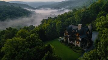 Luxurious mansion surrounded by misty mountains and trees photo