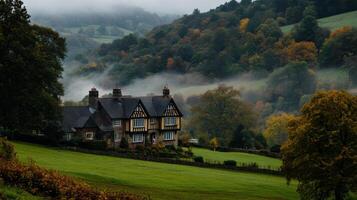 Classic English countryside manor with rolling hills and mist photo