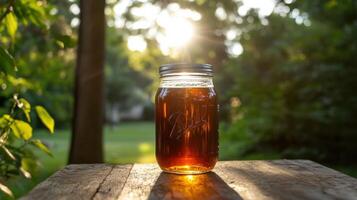 Cold brew coffee in mason jar with sunlight shining through photo