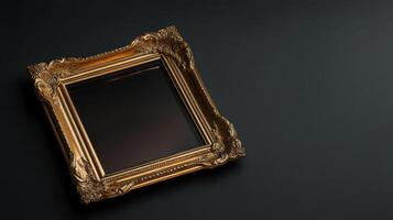 Elegant golden picture frame on dark background photo