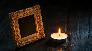 golden frame beside lit candle on dark surface photo