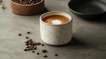 rustic ceramic cup of coffee with latte art and beans photo