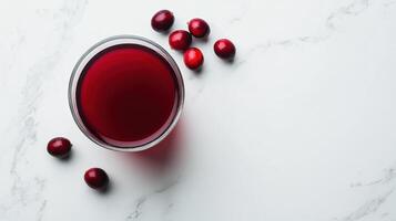 Fresh cranberry juice in clear glass with berries photo