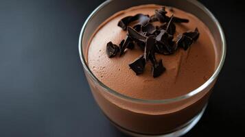 Creamy chocolate mousse topped with dark chocolate shavings photo