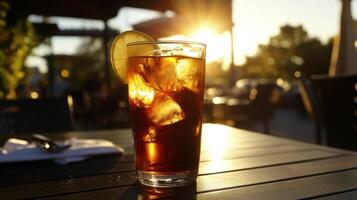 A glass of iced tea with lemon slices on the table photo