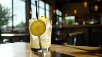 A lemonade drink with a straw sitting on a table photo