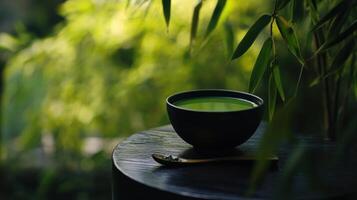 serene matcha tea bowl on wooden table surrounded by greenery photo