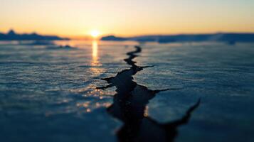 Melting glaciers with large cracks at sunset, rising sea levels photo