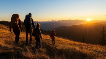 Hiking family enjoying sunset in mountains photo