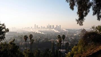 smog covered city skyline with power plants and palm trees photo