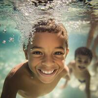 A group of cheerful kids playing and laughing underwater in a swimming pool, enjoying summer fun and friendship. photo