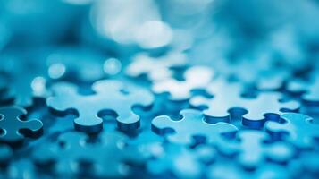 A close-up of blue jigsaw puzzle pieces, symbolizing problem-solving, teamwork, strategy, and mental challenges in education and brain games. photo