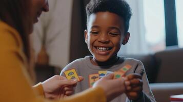 A smiling child playing an educational card game with an adult, representing fun learning, early childhood education, and cognitive development. photo