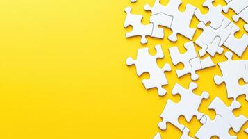 Assorted white puzzle pieces scattered on a bright yellow background create a playful and inviting atmosphere for puzzle enthusiasts photo