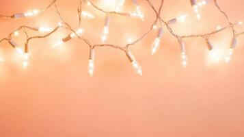 Warm glow of decorative string lights illuminating a peach wall during a cozy indoor gathering at sunset photo