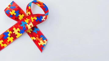 Colorful puzzle pattern ribbon symbolizes autism awareness at a fundraising event held in a community center during April's Autism Awareness Month photo