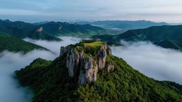 Majestic Mountain Peak Soaring Above a Sea of Clouds Breathtaking Aerial View of a Serene Landscape photo