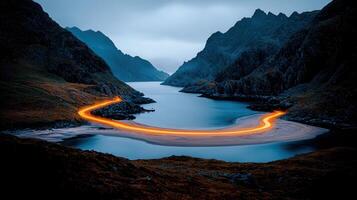 Serene Coastal Road at Dusk Light Trails on a Scenic Bay between Majestic Mountains photo