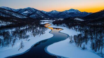 Serene Winter River Winding Through Snowy Mountains at Sunset Breathtaking landscape photo
