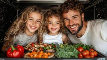 Happy family with two daughters peeking from oven with healthy food Delicious roasted vegetables and chicken meal prep photo