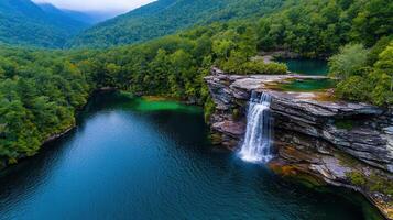 Stunning Waterfall cascading into a serene lake nestled within a lush green forest landscape Breathtaking nature scenery photo