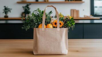 Reusable Tote Bag Filled with Fresh Produce and Flowers on Kitchen Counter photo