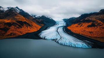 Majestic Glacier River flows between Autumnal Mountains in a Stunning Landscape photo