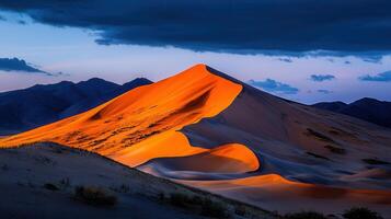 Majestic Desert Landscape Golden Sands and Dramatic Mountains at Sunset photo