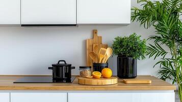 Modern minimalist kitchen countertop design with bamboo cutting boards wooden utensils black cookware and potted plants photo