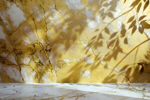A textured wall with golden hues and shadows from foliage creates a warm, artistic atmosphere. photo