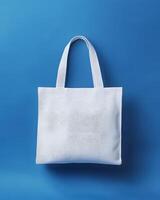 White Canvas Tote Bag Mock up Against Blue Background photo