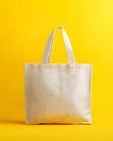 Off-White Tote Bag Mock up Against Yellow Background photo