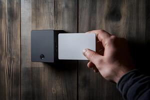 Hand Using Access Card on Wall-Mounted Reader photo