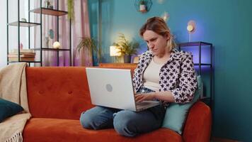 Sad woman using laptop notebook typing browsing working loses bad news game fail computer virus video