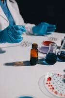 A person in a lab coat is holding a vial photo