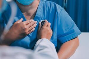 A doctor is checking a patient's heart rate photo