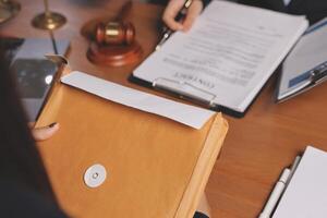 A lawyer holding a file and a pen on a desk photo