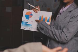 A woman in a business suit holding a clipboard with graphs on it photo