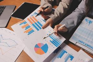 Business people working on graphs and papers photo