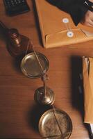 A lawyer's desk with a scale, a gavel, and a box of documents photo